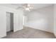Bright bedroom with ceiling fan, closet, neutral carpet, and white walls at 37422 Neukom Ave, Zephyrhills, FL 33541