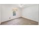 Cozy bedroom with neutral carpet, natural light, and simple window treatment at 37422 Neukom Ave, Zephyrhills, FL 33541