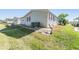 Exterior view of home showing siding, green grass, and AC unit at 37422 Neukom Ave, Zephyrhills, FL 33541