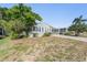 Well maintained single-story home with a carport and mature landscaping at 37422 Neukom Ave, Zephyrhills, FL 33541