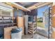 View of storage area in garage including work bench, shelving, and supplies at 37422 Neukom Ave, Zephyrhills, FL 33541