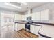 Efficient kitchen featuring white cabinets, and stainless steel appliances at 37422 Neukom Ave, Zephyrhills, FL 33541