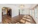 Bright and airy living room featuring hardwood floors, natural light, and a ceiling fan at 37422 Neukom Ave, Zephyrhills, FL 33541