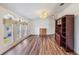 Bright living room featuring hardwood floors, large windows, and a built-in shelving unit at 37422 Neukom Ave, Zephyrhills, FL 33541