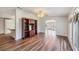 Inviting living room with hardwood floors, ceiling fan, and large shelving unit at 37422 Neukom Ave, Zephyrhills, FL 33541
