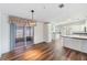 Open-concept living area with hardwood floors, island and access to a screened lanai at 37422 Neukom Ave, Zephyrhills, FL 33541