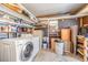 Utility room featuring washer, dryer, and storage shelves at 37422 Neukom Ave, Zephyrhills, FL 33541