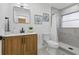 Modern bathroom featuring a wood vanity, stylish mirror, toilet and glass-enclosed shower at 3936 10Th N Ave, St Petersburg, FL 33713