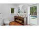 Modern bathroom with dual sinks, wooden vanity, and a view of the pool area at 432 39Th Ne Ave, St Petersburg, FL 33703
