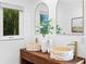 Stylish bathroom featuring vessel sinks, gold hardware, wood vanity, and a bright window at 432 39Th Ne Ave, St Petersburg, FL 33703