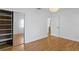 Bedroom with hardwood floors, white walls, closet, and access to another room at 432 39Th Ne Ave, St Petersburg, FL 33703