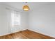 Bedroom with hardwood floors, white walls, and a window with natural light at 432 39Th Ne Ave, St Petersburg, FL 33703