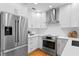 Modern kitchen featuring stainless steel appliances, white cabinets, and sleek countertops at 432 39Th Ne Ave, St Petersburg, FL 33703