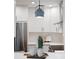 Updated kitchen featuring white cabinets, modern appliances, and stylish lighting fixtures at 432 39Th Ne Ave, St Petersburg, FL 33703