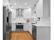 Modern kitchen featuring stainless steel appliances, white cabinets, and sleek countertops at 432 39Th Ne Ave, St Petersburg, FL 33703