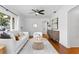 Cozy living room featuring neutral decor, a decorative fireplace, hardwood floors, and natural light at 432 39Th Ne Ave, St Petersburg, FL 33703