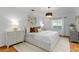 Comfortable main bedroom featuring stylish lamps, modern art, and soft bedding at 432 39Th Ne Ave, St Petersburg, FL 33703