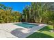 Beautiful backyard pool featuring turf and paver decking surrounded by lush tropical landscaping at 432 39Th Ne Ave, St Petersburg, FL 33703