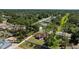 Beautiful aerial view captures a lovely home with a white vinyl fence, nestled in a vibrant, green and wooded neighborhood at 4344 Eldron Ave, North Port, FL 34286