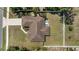 Overhead shot of a home reveals a lush green lawn, concrete driveway, and screened lanai with spa at 4344 Eldron Ave, North Port, FL 34286