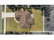 Bird's eye view showcases the home's roof, concrete driveway, lush yard, and the spa in the screened lanai at 4344 Eldron Ave, North Port, FL 34286