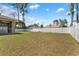 Spacious backyard with a vinyl fence, screened patio, and hot tub at 4344 Eldron Ave, North Port, FL 34286