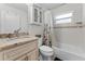 Bathroom features a vanity with granite countertops, a shower/tub combo and tile floors at 4344 Eldron Ave, North Port, FL 34286