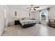 Primary bedroom with window, ceiling fan, tile flooring and ensuite bathroom at 4344 Eldron Ave, North Port, FL 34286