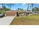 Well-manicured front yard and exterior elevation of home with neutral paint at 4344 Eldron Ave, North Port, FL 34286