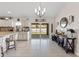 Open floor plan with island, dining area, wine rack and sliding glass doors to screened porch at 4344 Eldron Ave, North Port, FL 34286