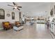 Open-concept living room flows to kitchen with tiled floors, modern decor, and ample natural light at 4344 Eldron Ave, North Port, FL 34286