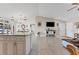 Spacious living room with tiled floors, connecting to a kitchen, creating a seamless flow for entertaining at 4344 Eldron Ave, North Port, FL 34286