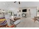 Bright and airy living room with tiled floors, open layout, and a seamless transition to the modern kitchen at 4344 Eldron Ave, North Port, FL 34286