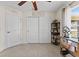 Room featuring tile floors, a ceiling fan, closet doors and access to the backyard at 4344 Eldron Ave, North Port, FL 34286
