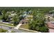 Street-side view reveals a home amidst a green and wooded neighborhood, with beautiful landscaping at 4344 Eldron Ave, North Port, FL 34286