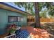 Private backyard featuring a wooden deck, shade trees, and covered outdoor space at 4730 15Th N Ave, St Petersburg, FL 33713