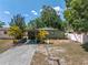 Charming home featuring tropical landscaping, a carport, and a well-maintained lawn at 4730 15Th N Ave, St Petersburg, FL 33713