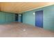 Attached garage interior with three blue doors and overhead lighting at 4730 15Th N Ave, St Petersburg, FL 33713