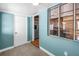 Hallway featuring blue walls, tile flooring, and an entry to the kitchen at 4730 15Th N Ave, St Petersburg, FL 33713