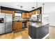 Updated kitchen features stainless steel appliances, wooden cabinets and black countertops at 4730 15Th N Ave, St Petersburg, FL 33713