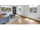 Sunlit living room with wood floors, light gray walls, modern windows and stylish front door at 4730 15Th N Ave, St Petersburg, FL 33713