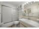 Bright bathroom with frosted shower door and vanity with cabinet storage at 5247 81St N St # 4, St Petersburg, FL 33709