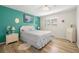Cozy bedroom with aqua accent wall, decorative rug, and light wood flooring at 5247 81St N St # 4, St Petersburg, FL 33709