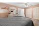 Bedroom featuring a queen-sized bed, wood floors, and light pink walls with dual closets at 5247 81St N St # 4, St Petersburg, FL 33709