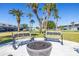 Community area with benches and a fire pit surrounded by lush landscaping at 5247 81St N St # 4, St Petersburg, FL 33709