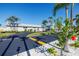 Well-maintained building with tropical landscaping, palm trees, and vibrant hibiscus flowers at 5247 81St N St # 4, St Petersburg, FL 33709