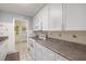 The kitchen features white cabinets, countertops and appliances, with tile backsplash and flooring at 5247 81St N St # 4, St Petersburg, FL 33709