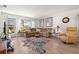 A view of the living room featuring a comfortable seating area, a zebra print rug, and bright, natural light at 5247 81St N St # 4, St Petersburg, FL 33709