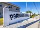 Street view of condo complex with 'Paradise Shores' sign welcoming residents and visitors at 5247 81St N St # 4, St Petersburg, FL 33709