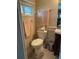 Bathroom featuring a toilet, vanity, towel bars, and a window with natural light at 57 Harbor Way # 24, Palm Harbor, FL 34684
